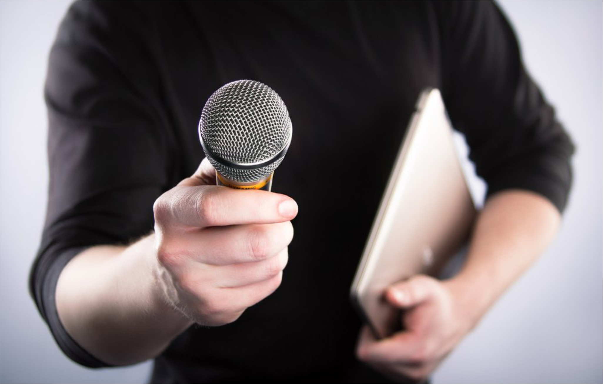 A singing man with a microphone in his hand
